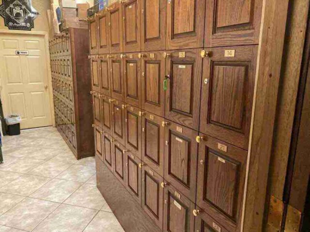 membership-lounge - 7 Rows of numbered, premium wooden humidified cigar lockers with brass nameplates and locks in the private member locker area at F&M Cigars.